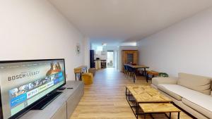 a living room with a large flat screen tv at Frisch sanierte Ferienwohnung in Altensteig