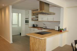 a kitchen with a wooden counter top in a room at Prince's165 in Knokke-Heist