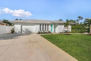 a large white house with a driveway at Naples Paradise Near The Beach! in Naples