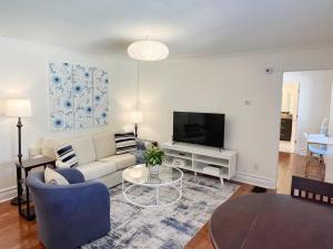 a living room with a couch and a tv at Modern 1BR apt in the heart of downtown Wilmington in Wilmington