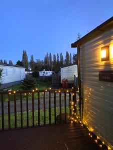 a deck with lights on the side of a garage at Short escape within Billing Aquadrome in Northampton