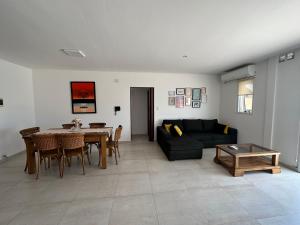 a living room with a table and a couch at Dpto 15 - Colon - 2 DORMITORIOS - PQ ALQUILERES TEMPORARIOS in Colón