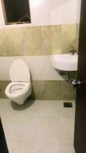 a bathroom with a toilet and a sink at hotel royal night in Ahmedabad