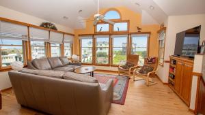 a living room with a couch and a tv at Semi-Oceanfront, Ocean Views, Private Pool, Hot Tub, CI1, Ocean View in Sanderling