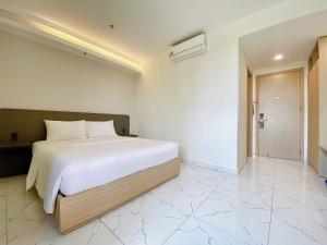 Postel nebo postele na pokoji v ubytování The Luxe Hotel Châu Đốc