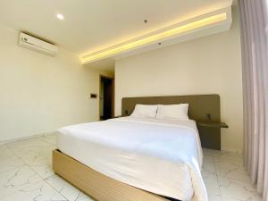 Postel nebo postele na pokoji v ubytování The Luxe Hotel Châu Đốc