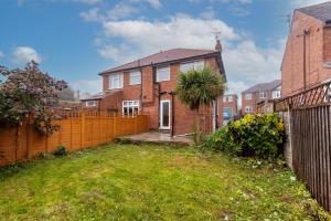 a brick house with a fence and a yard at 2 Bedroom House in Chilwell - Perfect for Families and Business in Beeston