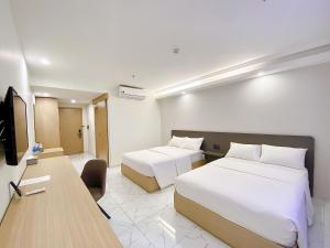 Postel nebo postele na pokoji v ubytování The Luxe Hotel Châu Đốc
