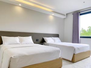 Postel nebo postele na pokoji v ubytování The Luxe Hotel Châu Đốc