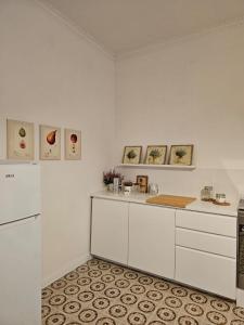 a kitchen with white cabinets and a refrigerator at Casa di Nonna Maria in Caserta