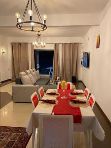 a living room with a dining room table with a red table cloth at Serenity northen 5-beds villa with private pool in Grand Baie