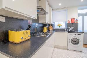 a kitchen with a yellow appliance on a counter at Henry Bell - Cosy 2-bedroom cottage in Helensburgh