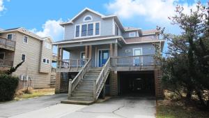 a large house with a garage in front of it at Oceanside, Hot Tub, Close to beach, Community Pool, CP5, Easy Breezes in Corolla