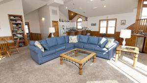 a living room with a blue couch and a coffee table at Oceanside, Hot Tub, Close to beach, Community Pool, CP5, Easy Breezes in Corolla