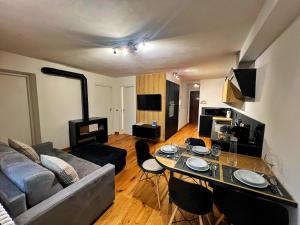 a living room with a couch and a table at Bonapace Dolomites Apartments in Madonna di Campiglio