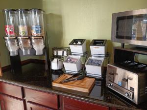 a kitchen counter with utensils on top of it at Americas Best Value Inn & Suites-Alvin/Houston in Alvin