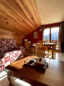a living room with a couch and a table at T3 Champagny-en-Vanoise avec terrasse plein sud in Champagny-en-Vanoise
