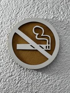 a no smoking sign on top of a bed at apartament la cova in Peralada