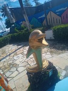 a statue of a dolphin with its mouth open at Soul Lounge Hostel in São Luís