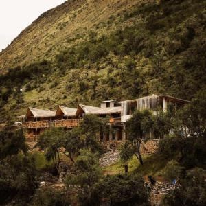 a house on a hill with a mountain at Refugios Salkantay - "StaySoraypampa - Accommodation near Humantay Lake and Salkantay Trek" in Cusco