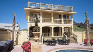 a large house with a balcony and a pool at OCEANFRONT, 18 BRs, ELEV, Theater, Rec Room, Poolside Bar, Luxury, EP204, Grande Ritz Carolina in Kill Devil Hills
