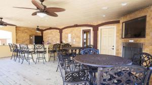 a dining room with tables and chairs and a ceiling fan at OCEANFRONT, 18 BRs, ELEV, Theater, Rec Room, Poolside Bar, Luxury, EP204, Grande Ritz Carolina in Kill Devil Hills