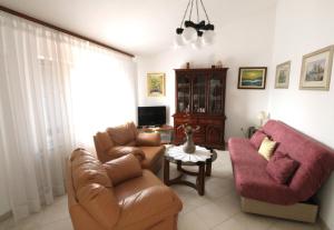 a living room with a couch and two chairs at Apartments Noel in Zambratija