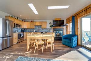a kitchen with a table and a blue chair at Sanderling Sea Cottages, Unit 10 in Waldport