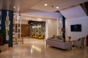 a lobby with couches and chairs in a building at Catalinas in San Miguel de Tucumán