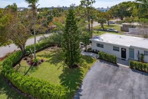 an aerial view of a house with a tree at Lovely 2-Bdr w/Patio, Lake Park! in Naples
