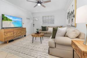 a living room with a couch and a flat screen tv at Lovely 2-Bdr w/Patio, Lake Park! in Naples