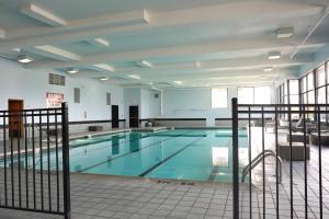 a large swimming pool in a building at American Inn & Suites in Waterford