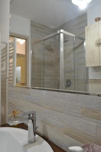 un bagno con lavandino, doccia e specchio di Mírame Casa Vacanza a Ovindoli Altre 224 foto