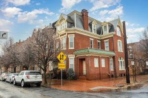 a large brick house with cars parked in front of it at Stylish Private 2 Bed Apt in Harrisburg