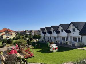 an aerial view of a house with a playground at Domki Słoneczka in Sarbinowo