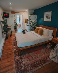 a bedroom with a large bed with a rug at Willow Pond Motel in Catskill