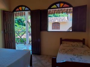 Ένα ή περισσότερα κρεβάτια σε δωμάτιο στο Pousada Paraíso do Mundo