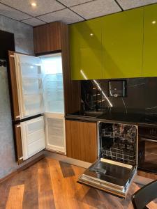 a kitchen with an empty refrigerator and an open oven at BRIVIBAS RESIDENCE - WAVE, free PRIVATE parking, free WIFI, self check-in in Riga