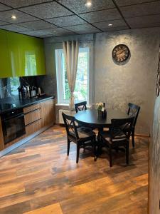 a dining room with a table and chairs in a kitchen at BRIVIBAS RESIDENCE - WAVE, free PRIVAT parking, free WIFI, self check-in in Riga