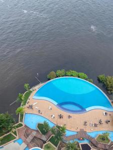 an aerial view of a swimming pool next to the water at Tropical executive in Manaus