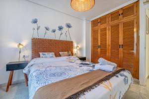 a bedroom with a large bed with a wooden headboard at Zafiro Apartment&Parking in the historical centre in Córdoba