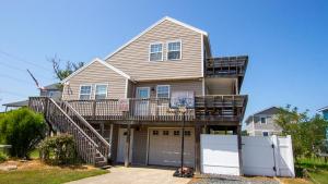 a house with a basketball hoop in front of it at Oceanside, Hot Tub, Close to beach, KD231, WindOver in Kill Devil Hills