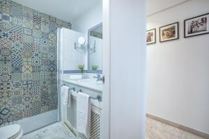 a bathroom with a shower and a toilet and a sink at Zafiro Apartment&Parking in the historical centre in Córdoba +21 photos
