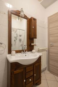 a bathroom with a sink and a mirror at Appartamenti - Here&Now in front of The Castle in Tresana