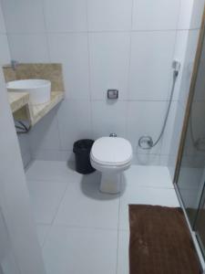 a white bathroom with a toilet and a sink at PRIME HOSPEDAGENS - Residencial Bellágio in São Luís