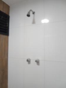 a bathroom with three shower heads on the wall at PRIME HOSPEDAGENS - Residencial Bellágio in São Luís