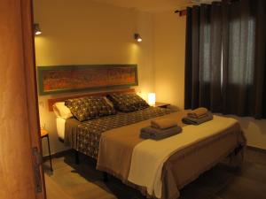 a bedroom with a bed and a window at Bungalow LIDO-Playa Roca residence with sea front access - Free AC - Wifi in Costa Teguise +14 photos