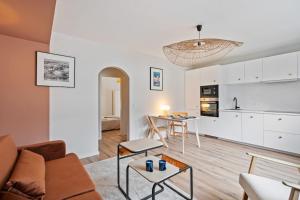 a living room with a couch and a table at Contemporain 1BR Rétro Chic Quartier Bonnevoie in Luxembourg