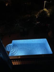 a blue tub sitting on a balcony at night at 2 Bed Flat - Sleeps 6 - Pool - Garden - Parking in Milna +4 photos