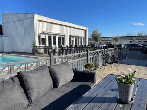 a couch sitting on a deck next to a pool at Hotel Herning in Herning